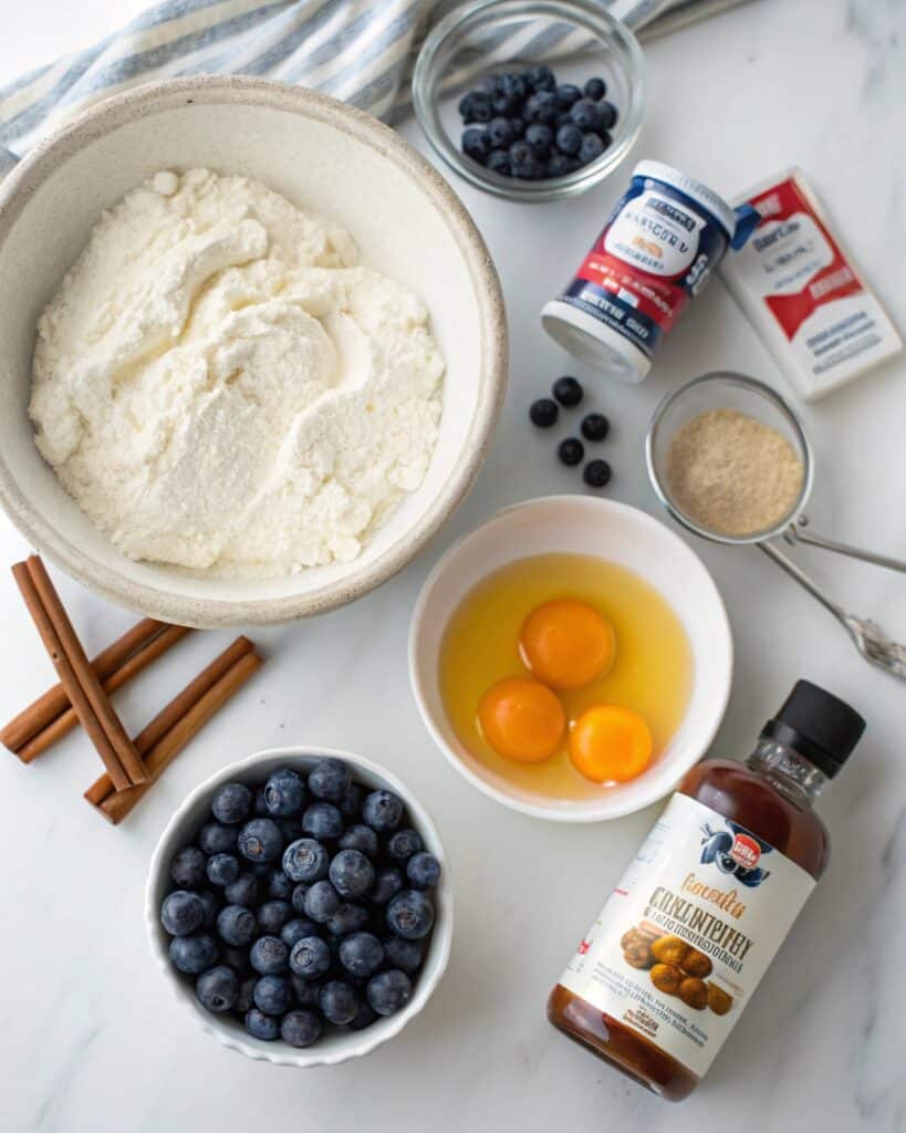 ingredients for cottage cheese blueberry cloud bread on marble surface